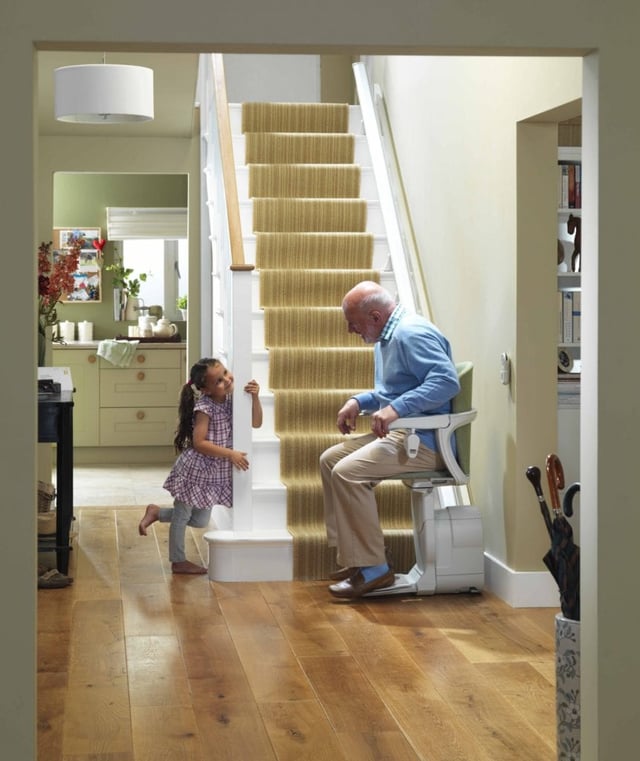Lifestyle - Grandfather on stairlift talking to granddaughter