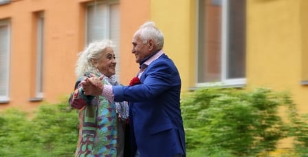 Elderly couple dancing in the street